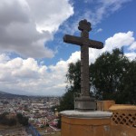 a large cross overlooking a city